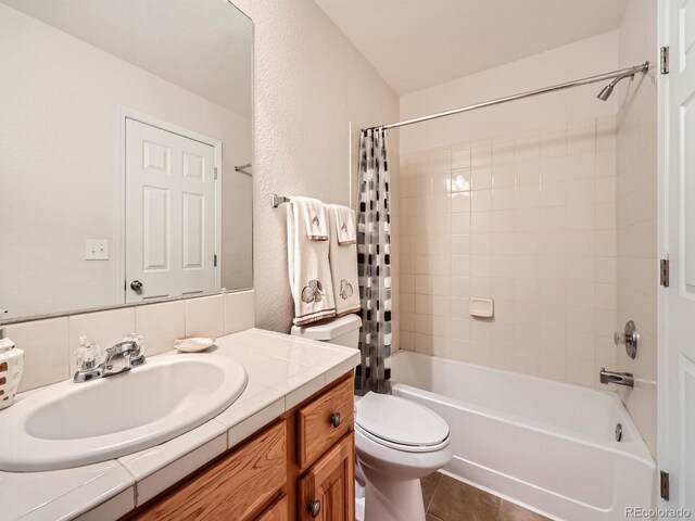 16366 E Fremont Ave Unit 11, Aurora, CO 80016 - bathroom with vanity, shower / bathtub combination with curtain, toilet, and tile patterned floors