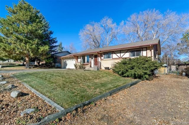 view of front of home with a front yard and a garage