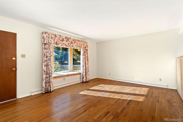 unfurnished room with wood-type flooring and baseboard heating