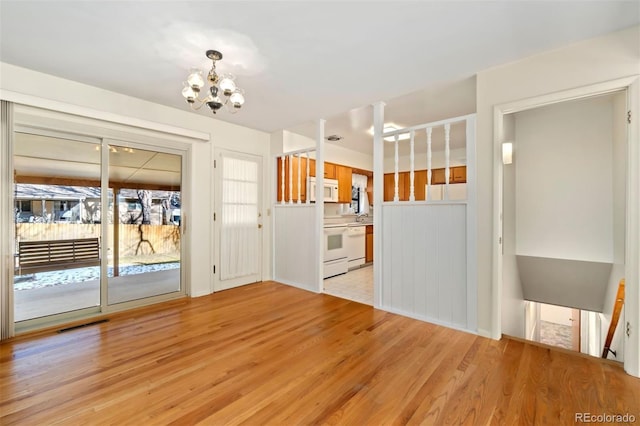 interior space featuring light hardwood / wood-style floors, a notable chandelier, and sink