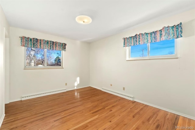 empty room with a baseboard radiator and wood-type flooring