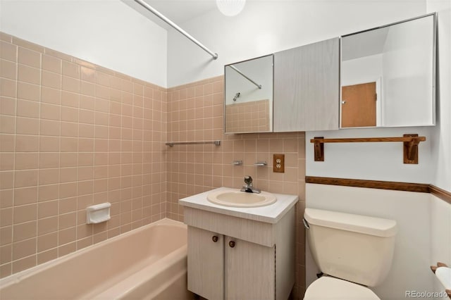 full bathroom featuring vanity, toilet, decorative backsplash, and tiled shower / bath combo