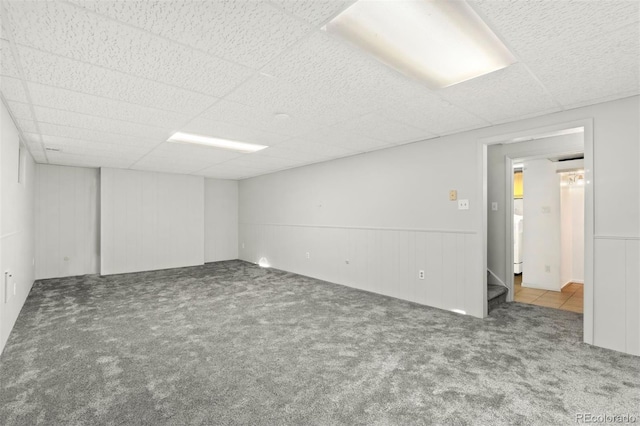 carpeted spare room featuring a paneled ceiling