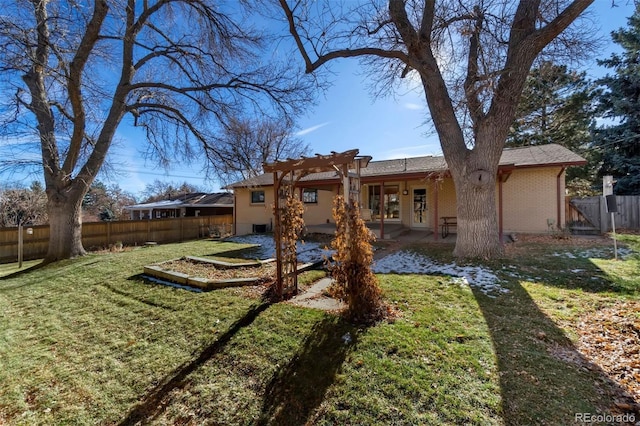 rear view of property featuring a pergola, a patio area, and a yard