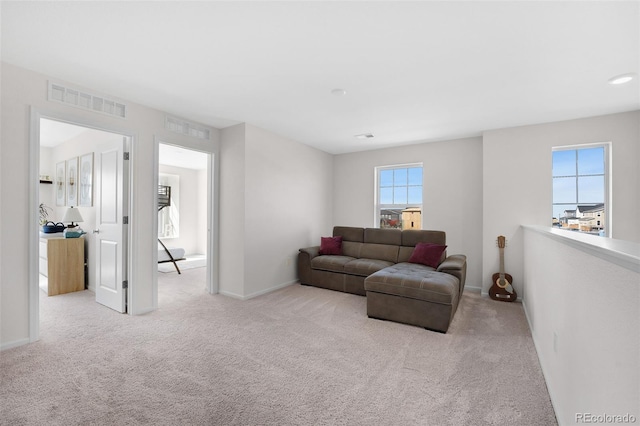 living room with light colored carpet and plenty of natural light