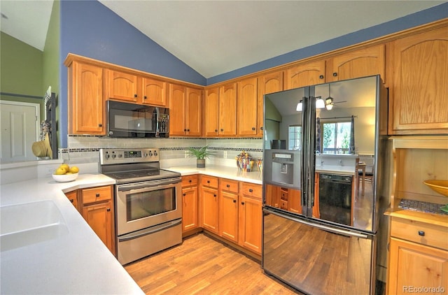 539 River View Dr Unit 1305, New Castle, CO 81647 - kitchen with black appliances, vaulted ceiling, light countertops, light wood-style flooring, and decorative backsplash