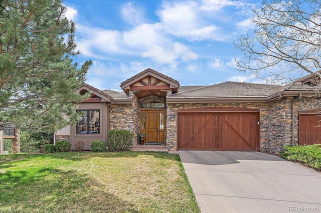 1015 Nob Hill Rd, Evergreen, CO 80439 - view of front of home featuring a front lawn, an attached garage, a tile roof, driveway, and stone siding