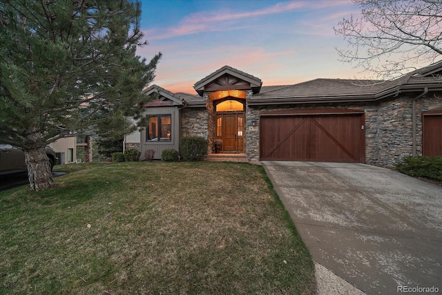 1015 Nob Hill Rd, Evergreen, CO 80439 - view of front of home with stone siding, an attached garage, a front yard, and concrete driveway