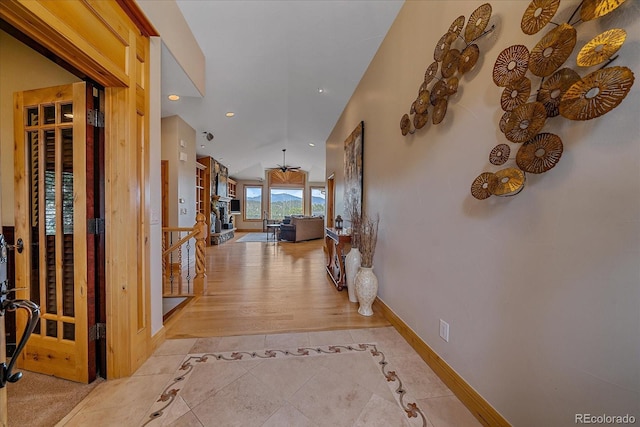 1015 Nob Hill Rd, Evergreen, CO 80439 - corridor featuring recessed lighting, baseboards, lofted ceiling, and light tile patterned floors