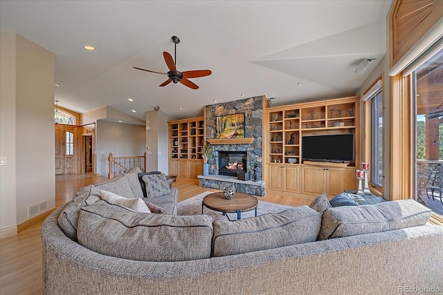 1015 Nob Hill Rd, Evergreen, CO 80439 - living area featuring a ceiling fan, wood finished floors, a fireplace, lofted ceiling, and visible vents