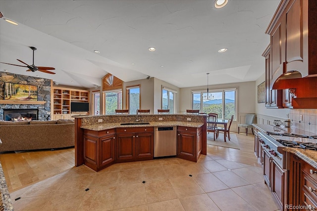 1015 Nob Hill Rd, Evergreen, CO 80439 - kitchen with stainless steel appliances, a sink, built in shelves, ceiling fan, and a fireplace