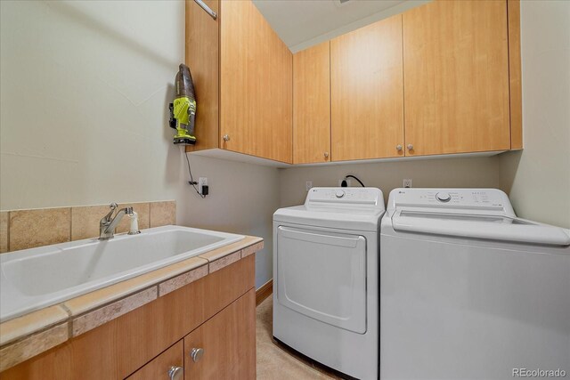 1015 Nob Hill Rd, Evergreen, CO 80439 - laundry room featuring washer and dryer, cabinet space, and a sink