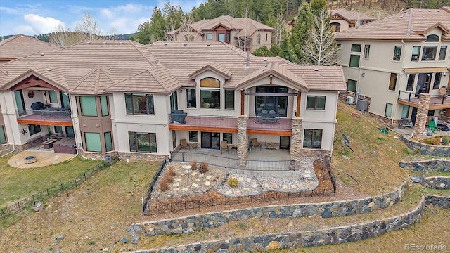1015 Nob Hill Rd, Evergreen, CO 80439 - back of house featuring a patio area, a tile roof, central AC, and stucco siding