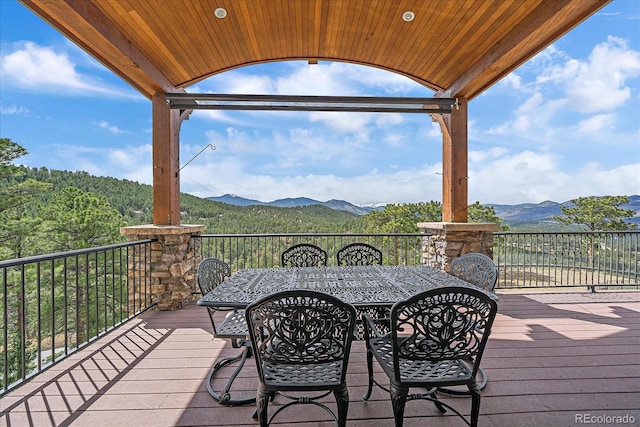 1015 Nob Hill Rd, Evergreen, CO 80439 - wooden terrace featuring outdoor dining area and a mountain view