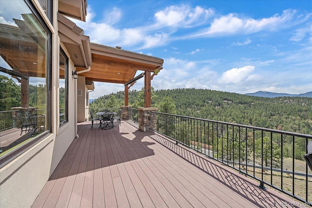 1015 Nob Hill Rd, Evergreen, CO 80439 - deck featuring a wooded view and a mountain view