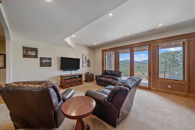 1015 Nob Hill Rd, Evergreen, CO 80439 - living room featuring arched walkways, visible vents, light carpet, and recessed lighting