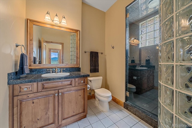 1015 Nob Hill Rd, Evergreen, CO 80439 - full bath featuring tile patterned floors, vanity, walk in shower, baseboards, and toilet