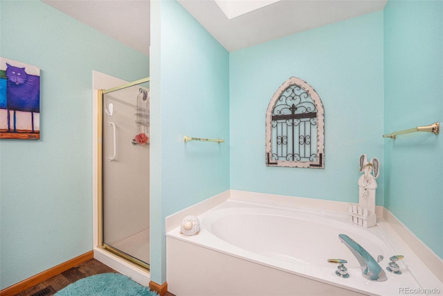 bathroom with a skylight and separate shower and tub