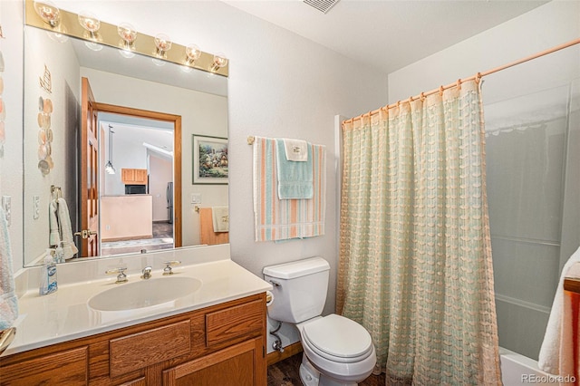 full bathroom featuring vanity, toilet, and shower / bath combo with shower curtain