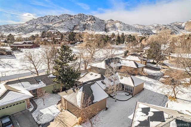 snowy aerial view with a mountain view