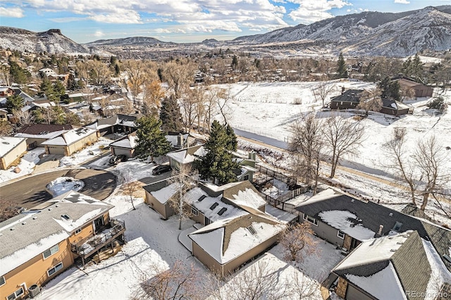 snowy aerial view with a mountain view