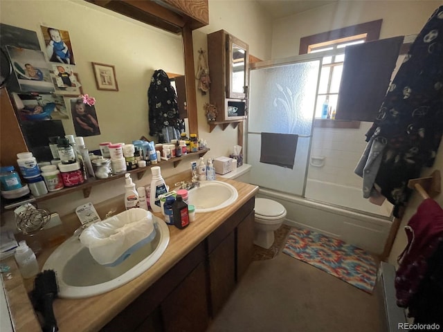11798 Sidney Rd, Golden, CO 80403 - bathroom featuring toilet, enclosed tub / shower combo, and double vanity