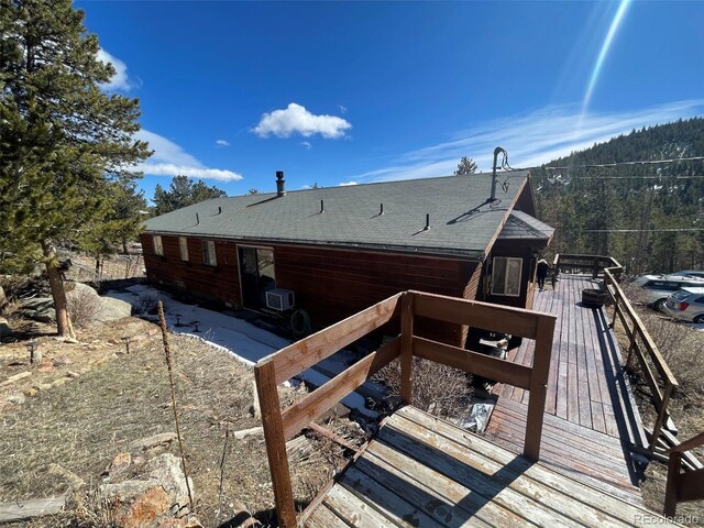 11798 Sidney Rd, Golden, CO 80403 - rear view of property featuring a deck, cooling unit, and a shingled roof