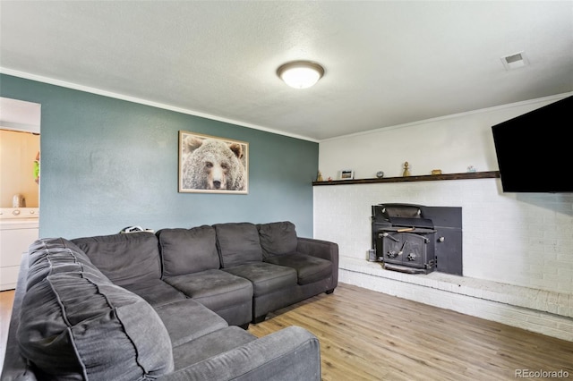 4035 Cantrell Dr, Colorado Springs, CO 80911 - living room featuring washer / dryer, wood finished floors, and crown molding