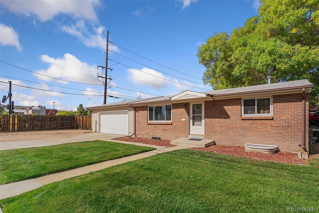 ranch-style home with a garage and a front lawn