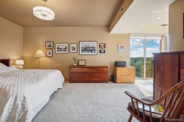 carpeted bedroom featuring a wall of windows, visible vents, and access to exterior