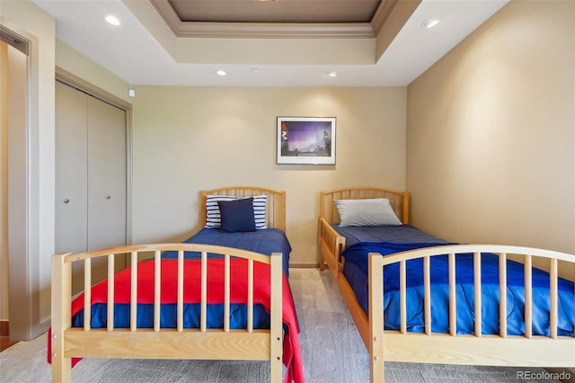 bedroom with a raised ceiling, carpet flooring, recessed lighting, and ornamental molding