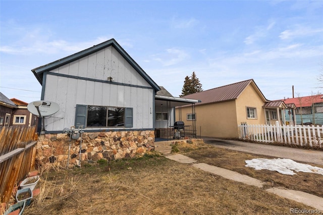 116 E 12th St, Leadville, CO 80461 - rear view of property featuring metal roof, stone siding, and fence