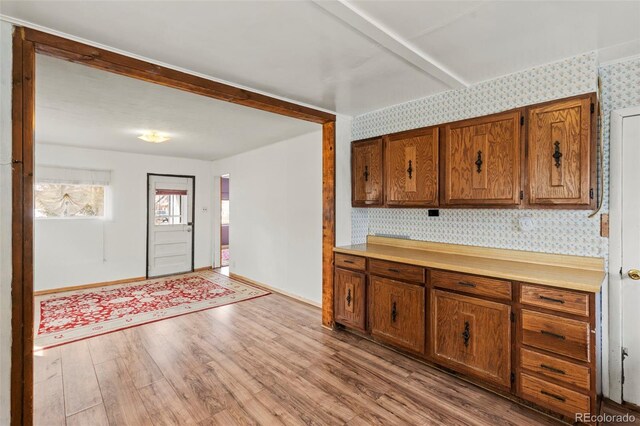 116 E 12th St, Leadville, CO 80461 - kitchen featuring baseboards, wallpapered walls, light countertops, brown cabinets, and wood finished floors