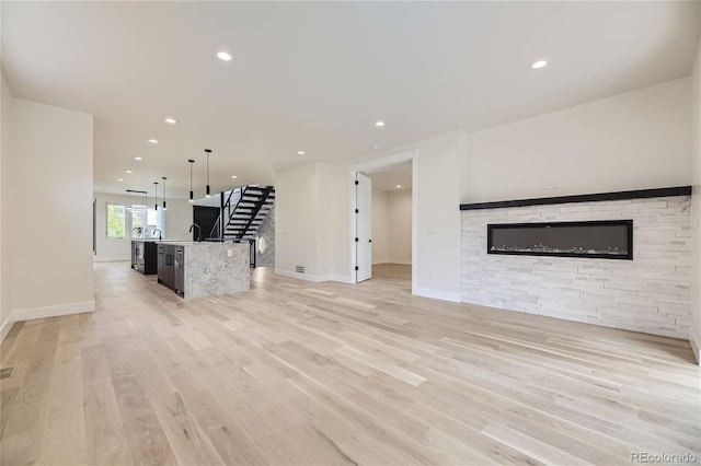 unfurnished living room with light hardwood / wood-style floors