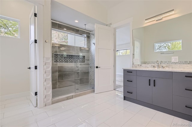 bathroom with tile floors, plenty of natural light, and vanity