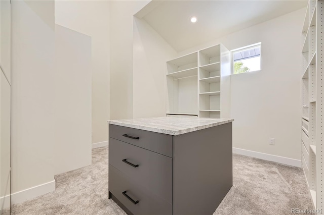 walk in closet featuring light colored carpet