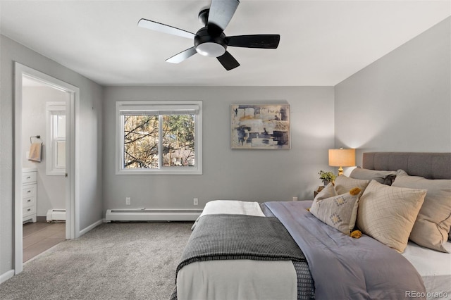 bedroom with ensuite bath, ceiling fan, light carpet, and a baseboard heating unit