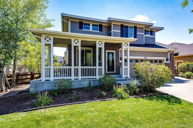 view of front facade featuring a garage, a porch, and a front lawn