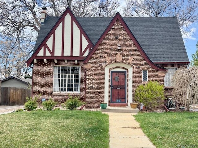 3055 N Albion St, Denver, CO 80207 - english style home featuring a shingled roof, brick siding, and a chimney