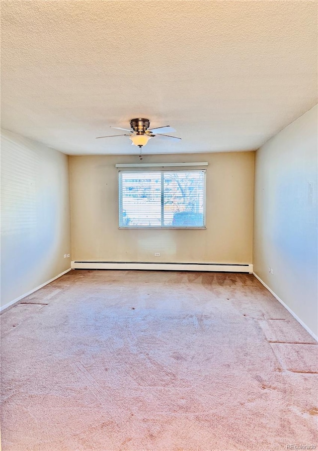 carpeted empty room featuring a baseboard heating unit, ceiling fan, baseboards, and a textured ceiling