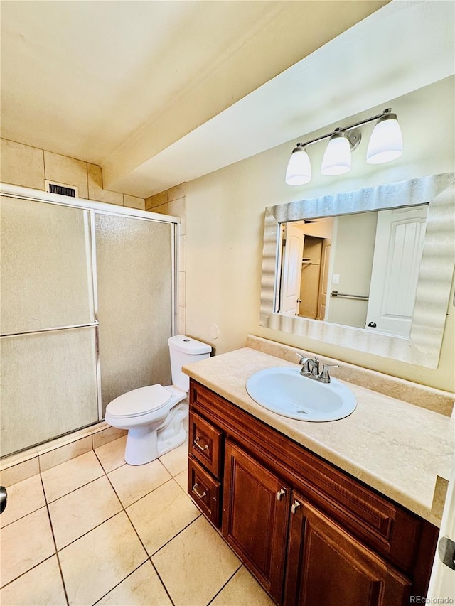 bathroom with vanity, visible vents, tile patterned flooring, a shower stall, and toilet