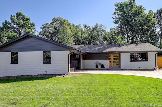 single story home featuring a garage and a front lawn