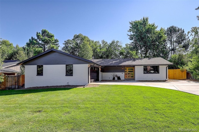 single story home with a front yard and a garage