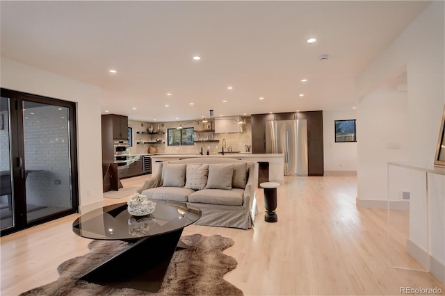 living room featuring sink and light wood-type flooring