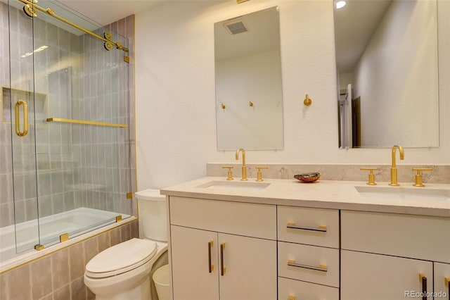 full bathroom with vanity, shower / bath combination with glass door, and toilet