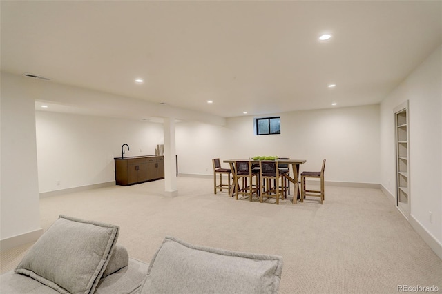 carpeted dining area featuring built in shelves