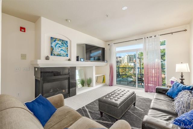 carpeted living room with a glass covered fireplace