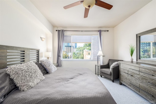 bedroom with multiple windows, carpet flooring, and a ceiling fan