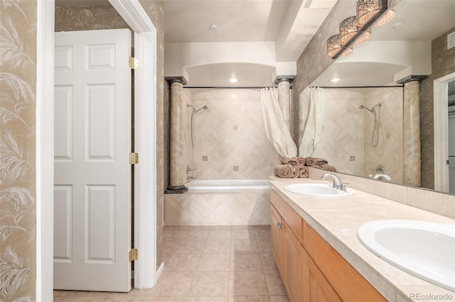 full bathroom with tile patterned flooring, a sink, tiled shower / bath combo, and ornate columns