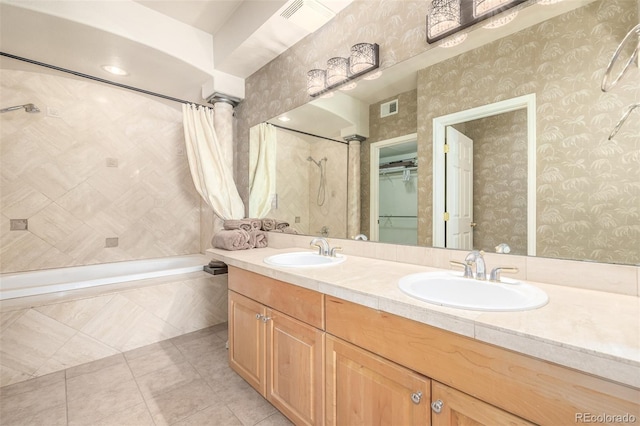 full bathroom featuring wallpapered walls, decorative columns, visible vents, and a sink